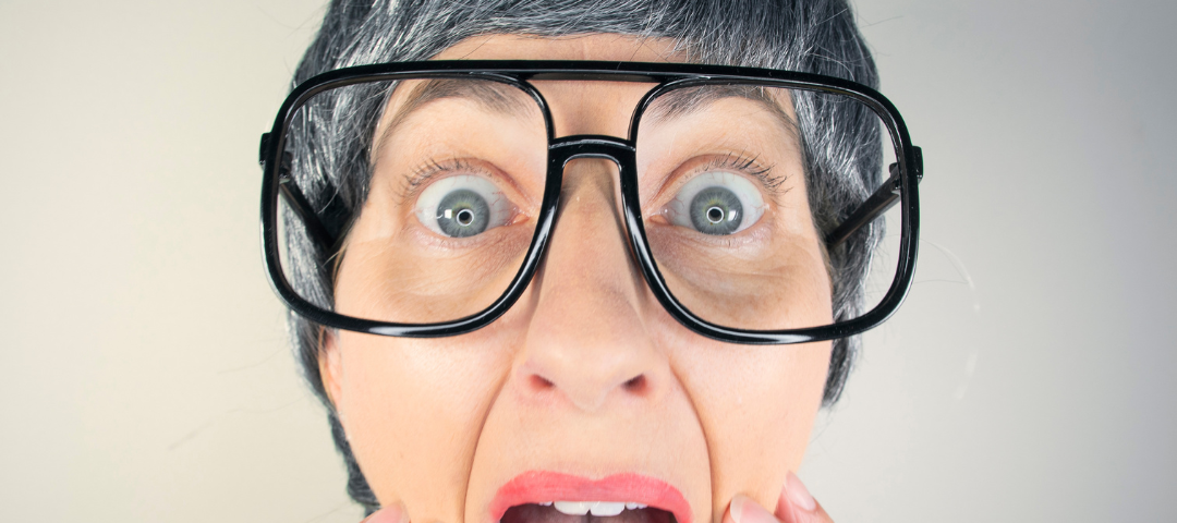 Funny picture of an older woman making a face with her mouth agape.