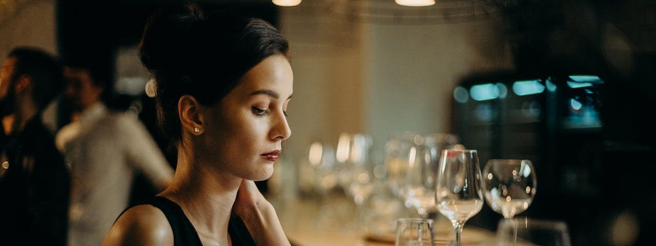 Single woman alone sitting in a bar