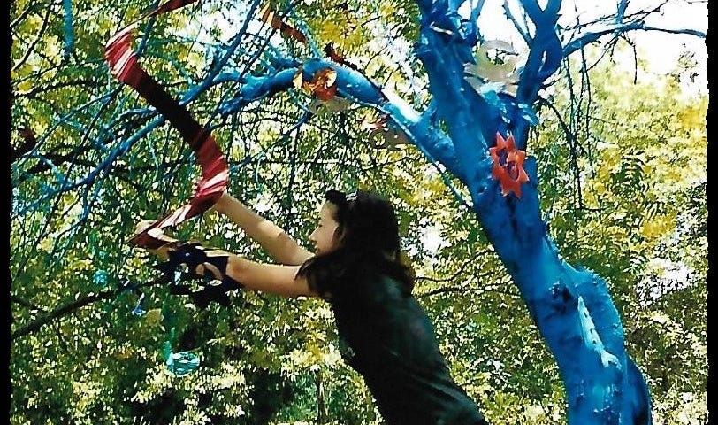 This is a photo of the last decorations placed on a dead apple tree that we painted blue for the party.