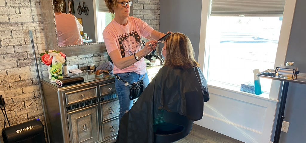 Dana trimming up her costumer’s bangs