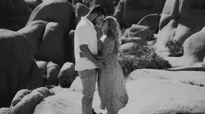 Young couple kissing in rocky desert