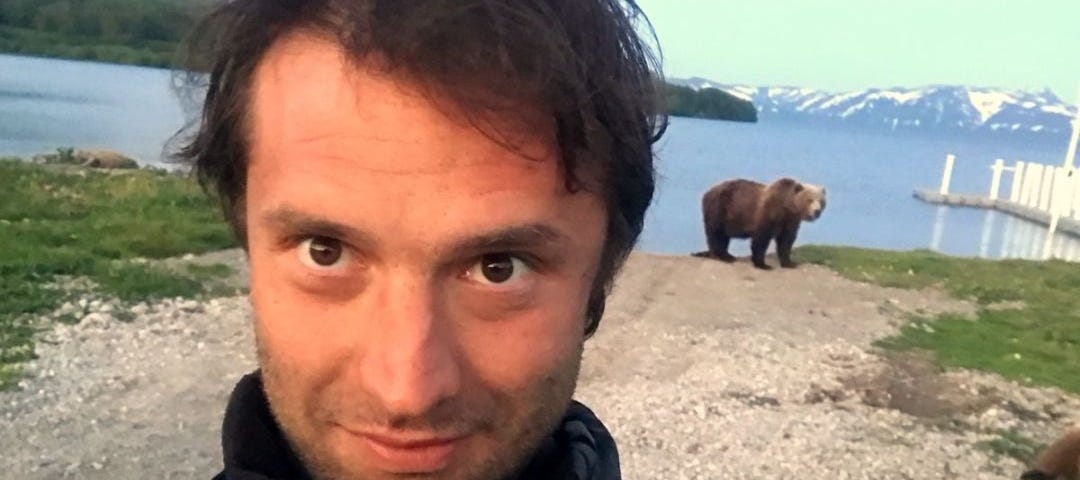 selfie with a brown bear at kurile lake in kamchatka, russia