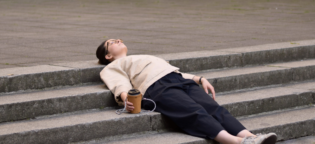 A woman lying on the stairs in Berlin — The German basic income may be the solution to your wellbeing