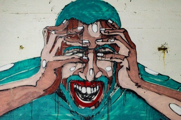 mural painting of a person with hands held across eyes and mouth ipen
