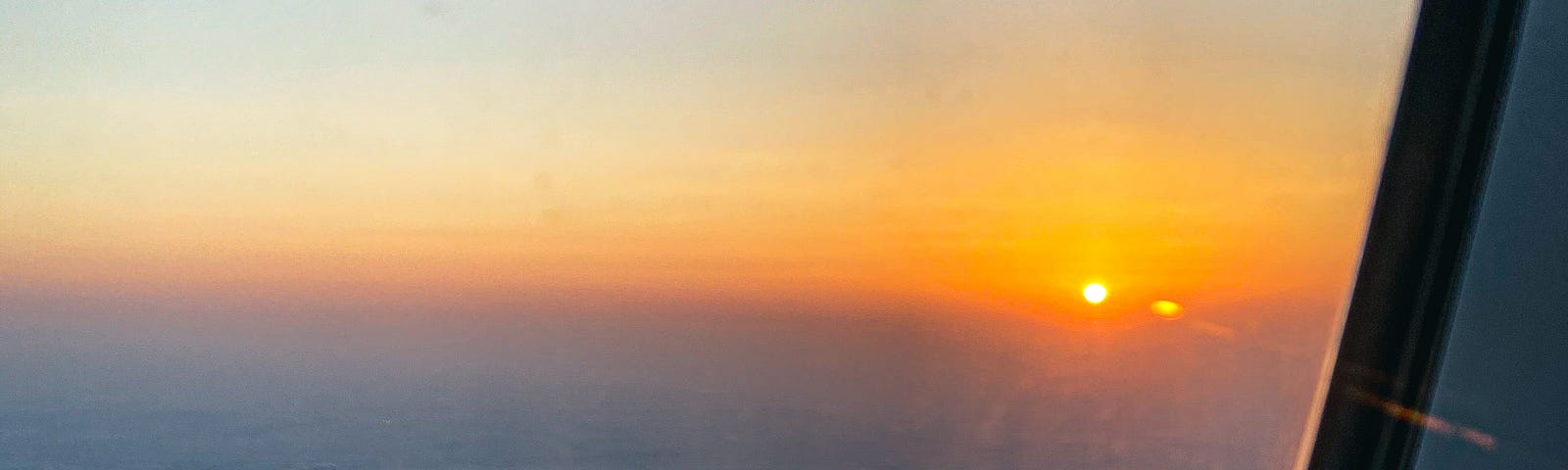 Sunset during my descent into Doha, Qatar. Photo by Author