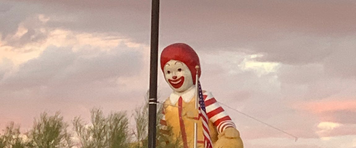 Photo of a giant red-headed clown by Mark Tulin.