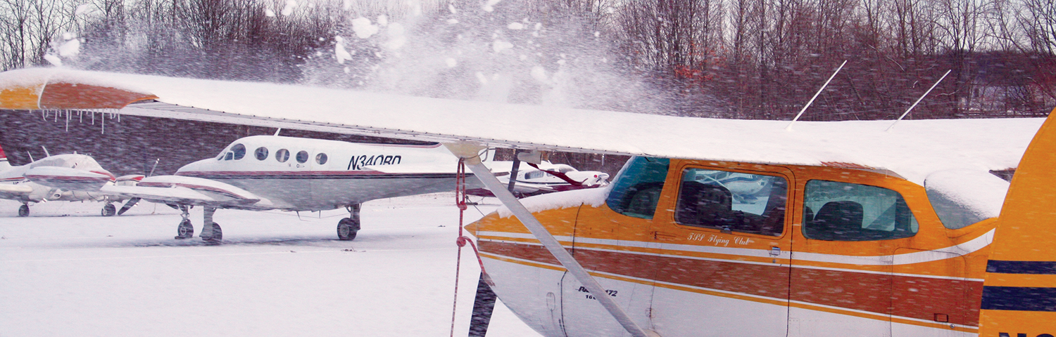 Airplanes with snow on them.