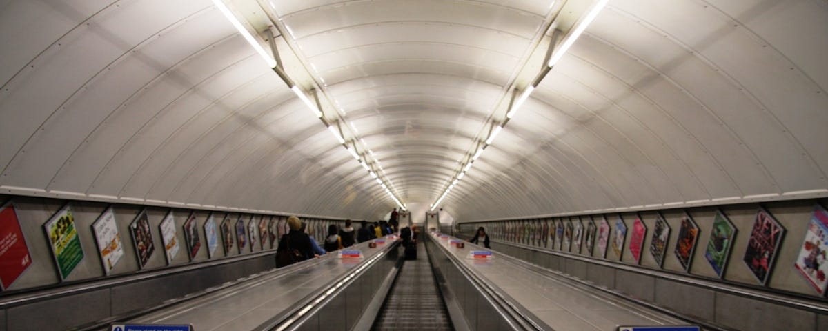 A view down from the top of the escalator leading to the Angel station on the London Underground.