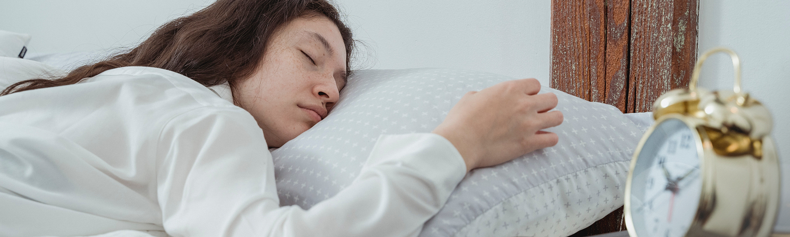 Woman sleeping next to her phone