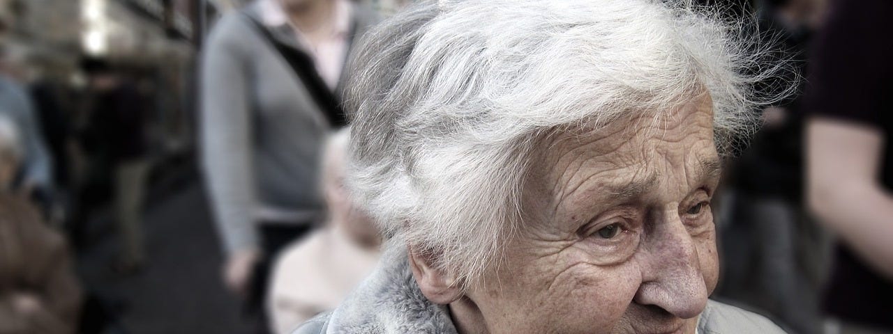 Photo of an elderly woman in an urban street setting