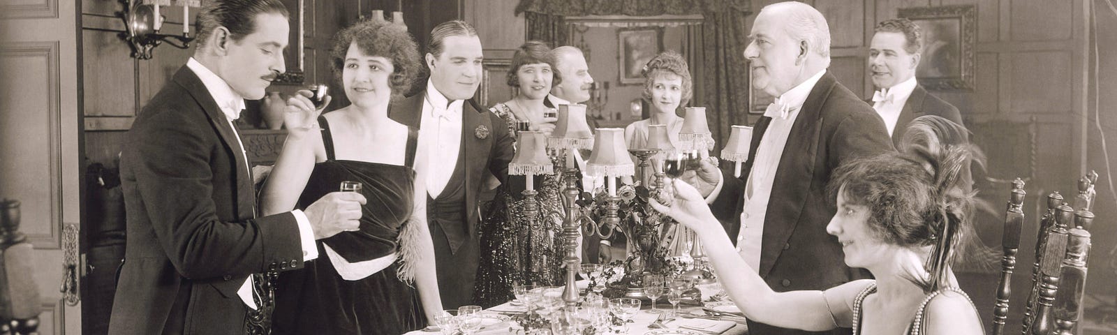 Vintage photo of black and white dinner party where the husband is being toasted by the guests