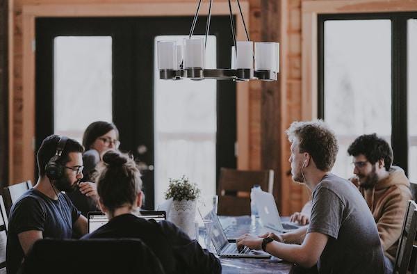 A team working around a table together