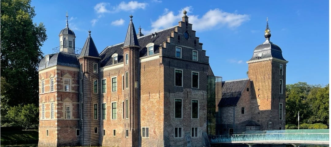 A classic castle with high walls surrounded by water.