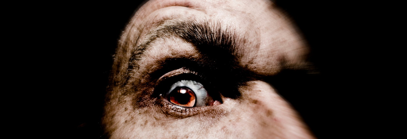 Close up of a creepy man’s brown eye.