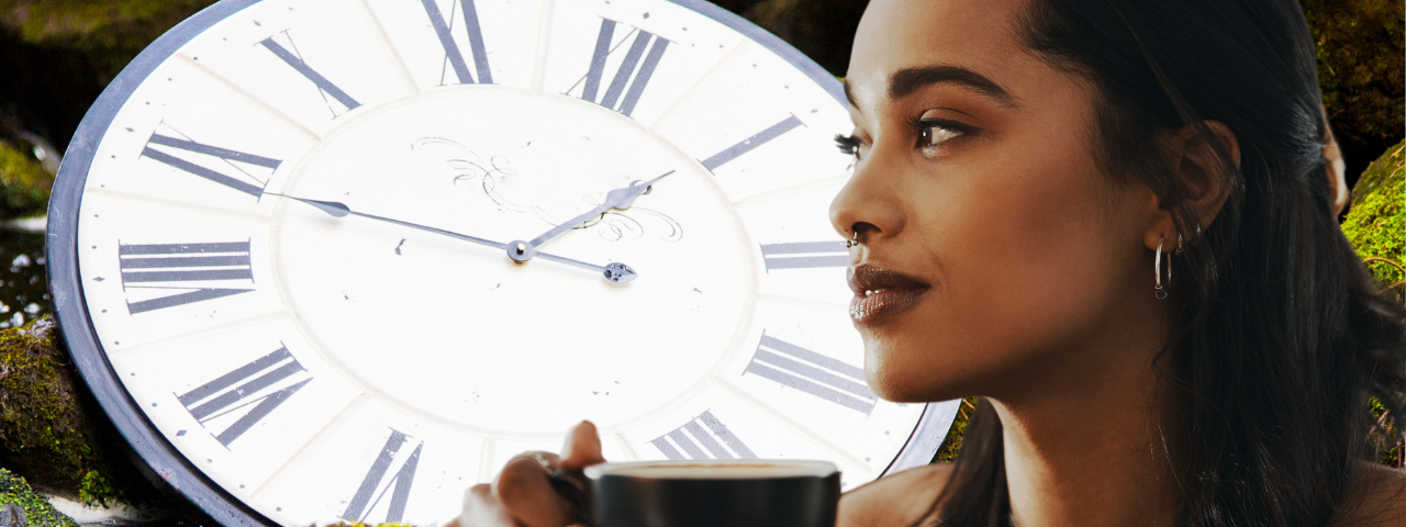 Woman holding cup staring at large clock above babbling brook