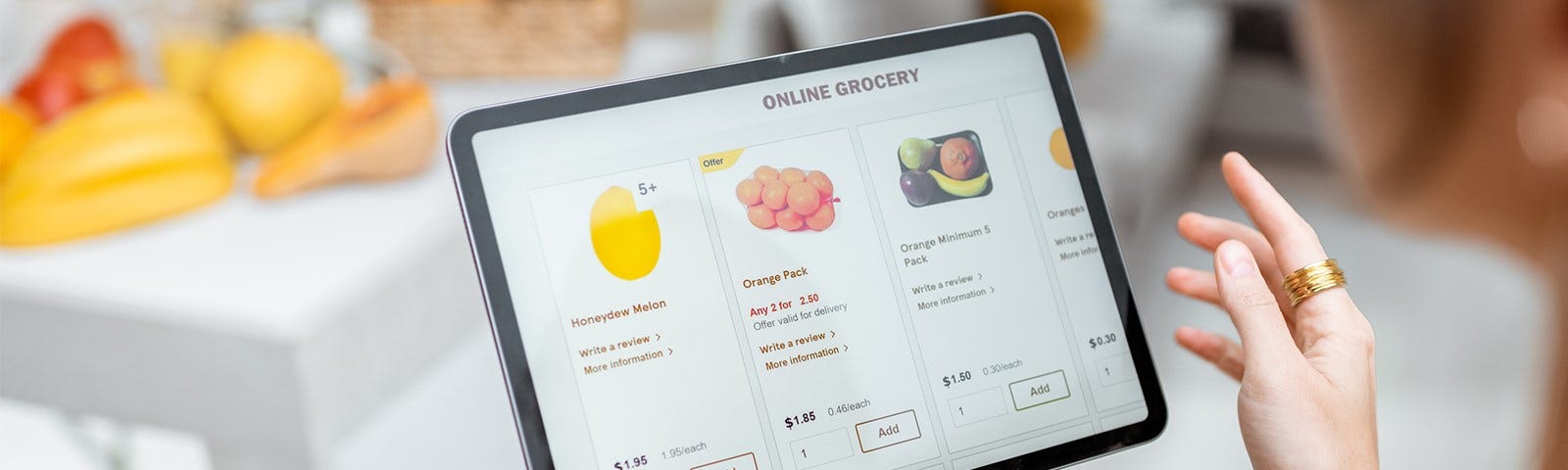 Women doing online grocery shopping by on a tablet in her kitchen