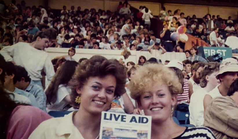 Author Gill McCulloch and sister at Wembley Stadium, London, during the Live Aid concert on July 13, 1985. Gill is holding a Live Aid concert program.