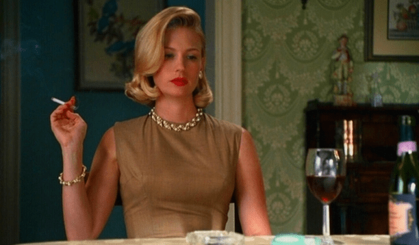 Betty Draper from Mad Men holding a cigarette.