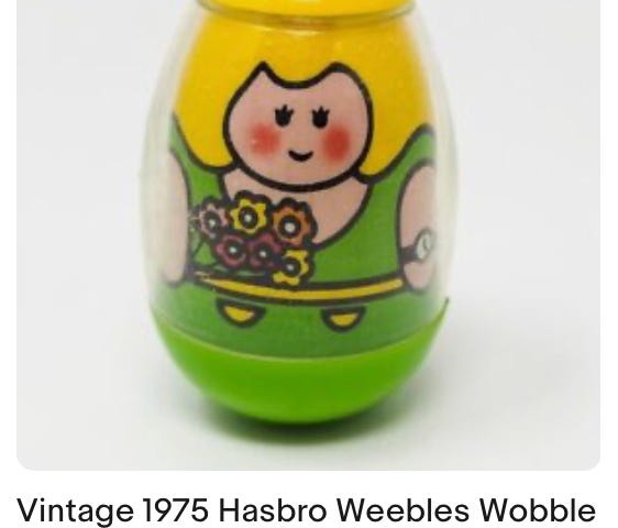 This photo is a screenshot from eBay. It shows a vintage 1975 Hasbro Weebles Wobble Blond Lady in Green with Flowers. The author purchased this item after seeing it advertised for sale on eBay.