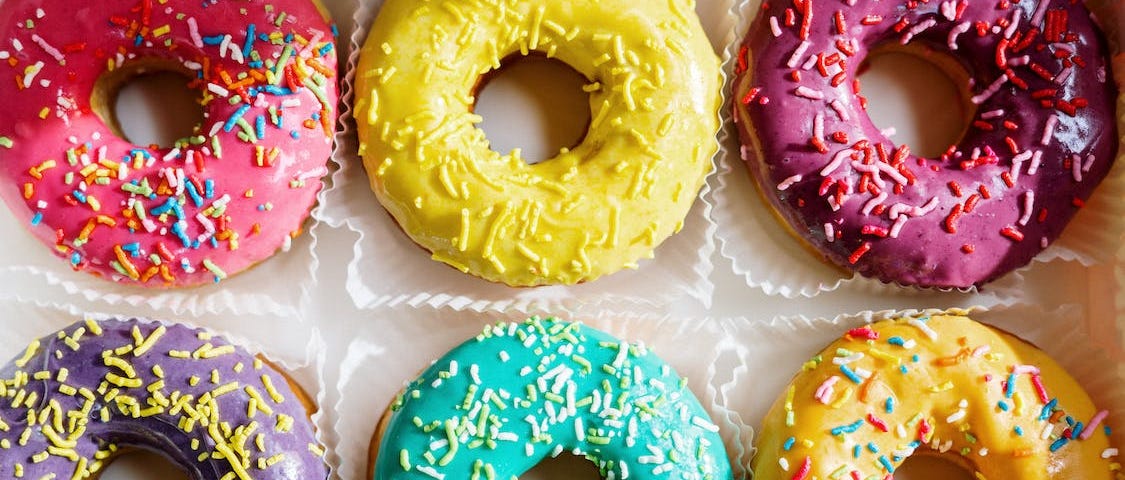 Multicolored Doughnuts on White Textile. How to reduce your sugar cravings. How to become a moderate sugar consumer. How I’ve managed to control my sugar cravings since I completed my 30-day no-sugar challenge