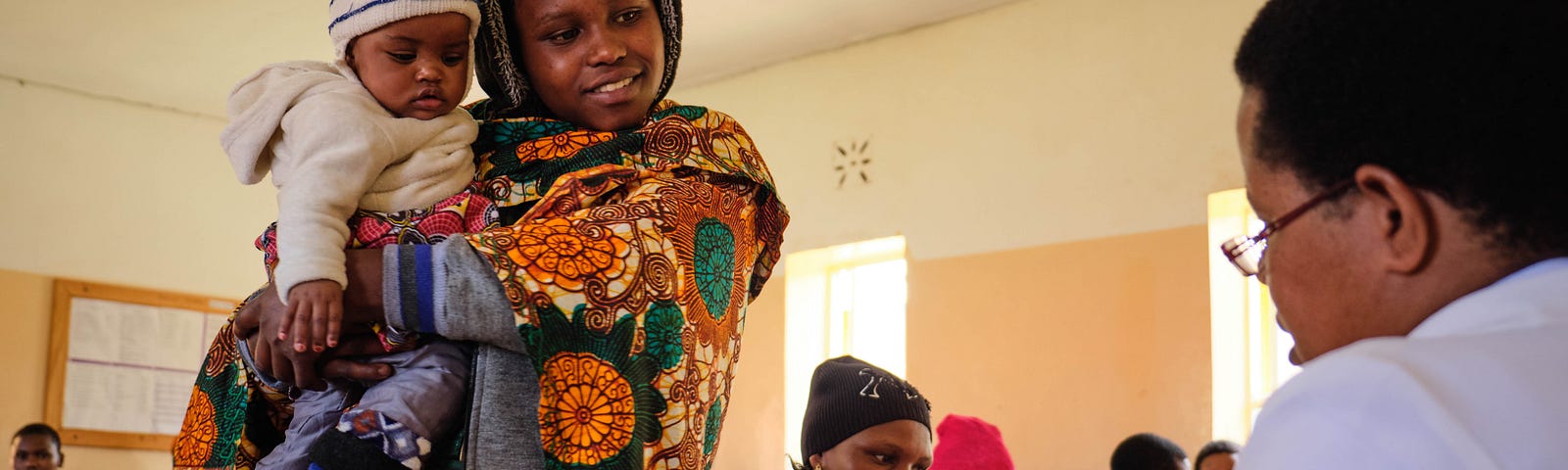 A mother enrolled in MomCare receives a postnatal check-up in Tanzania