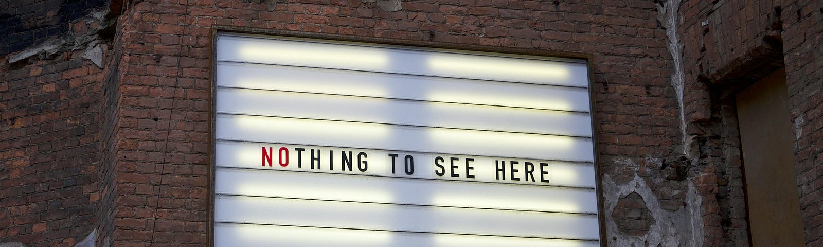 A billboard with the words “Nothing to see here” in capital letters.