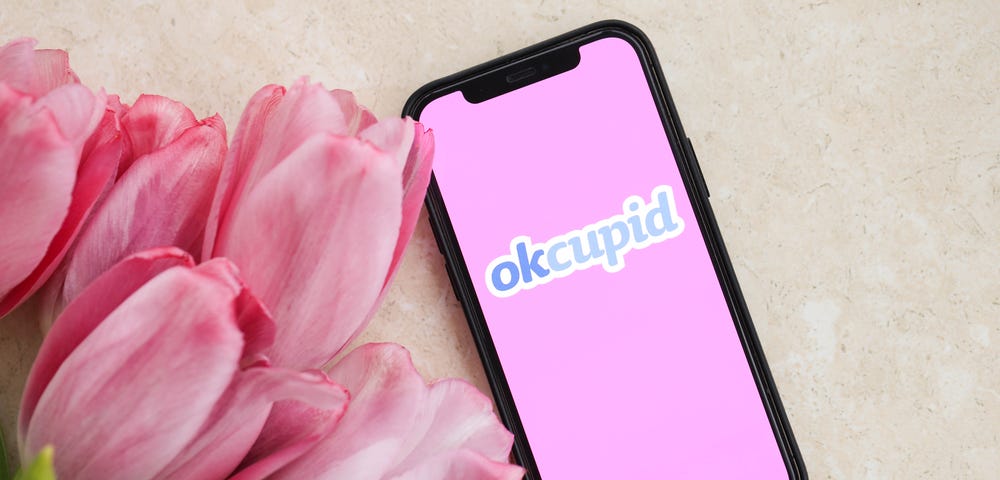 Phone wiith OKCupid app and flowers