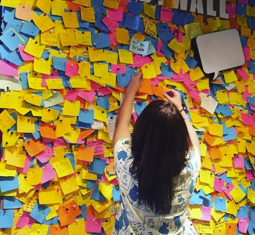 Woman infront of lots of sticky notes