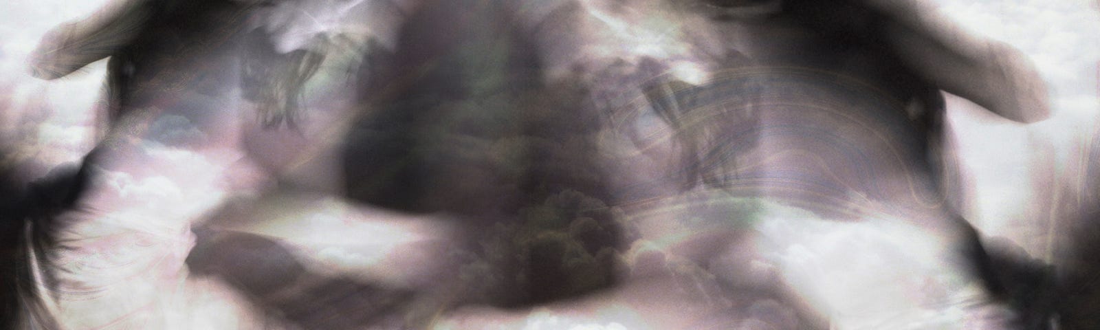 Composite image of a dancing mirrored to herself in a bank of clouds, the palette is in black and white with touches of red hues.
