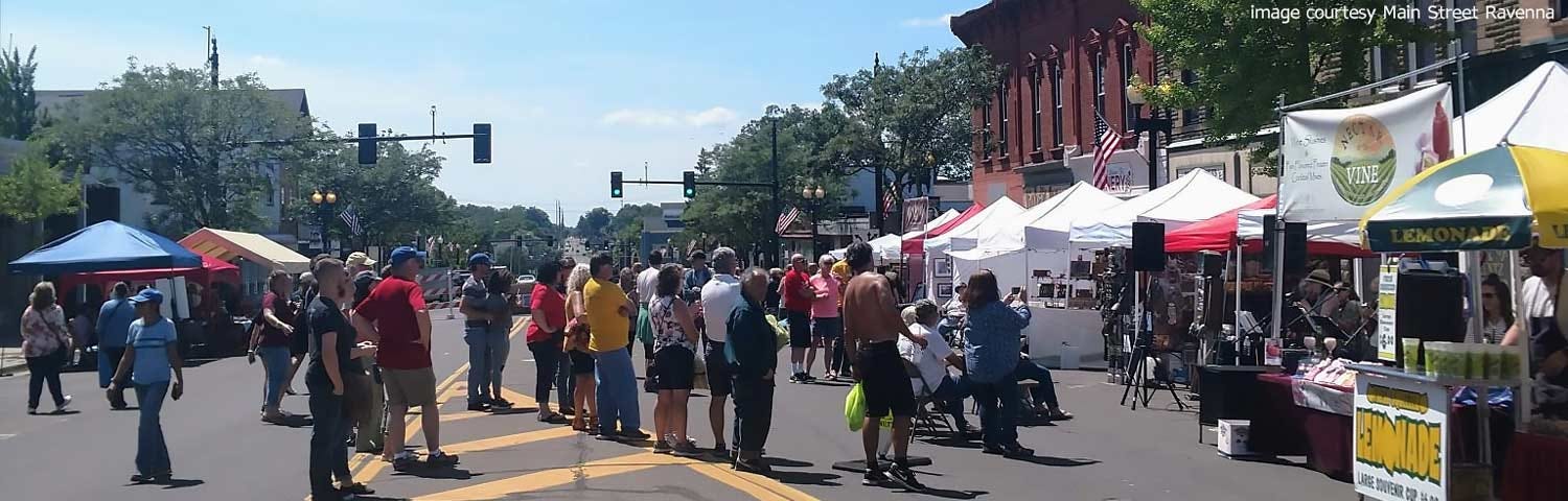 Spectators gather around vendors and artist booths at Main Street Ravenna’s Art on Main event.