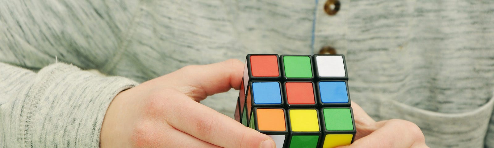 a person playing a rubik square game