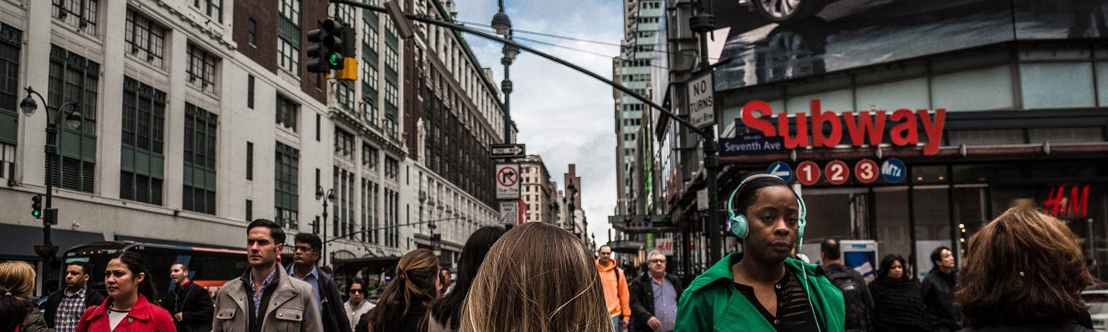 A person walks down a crowded New York City street.