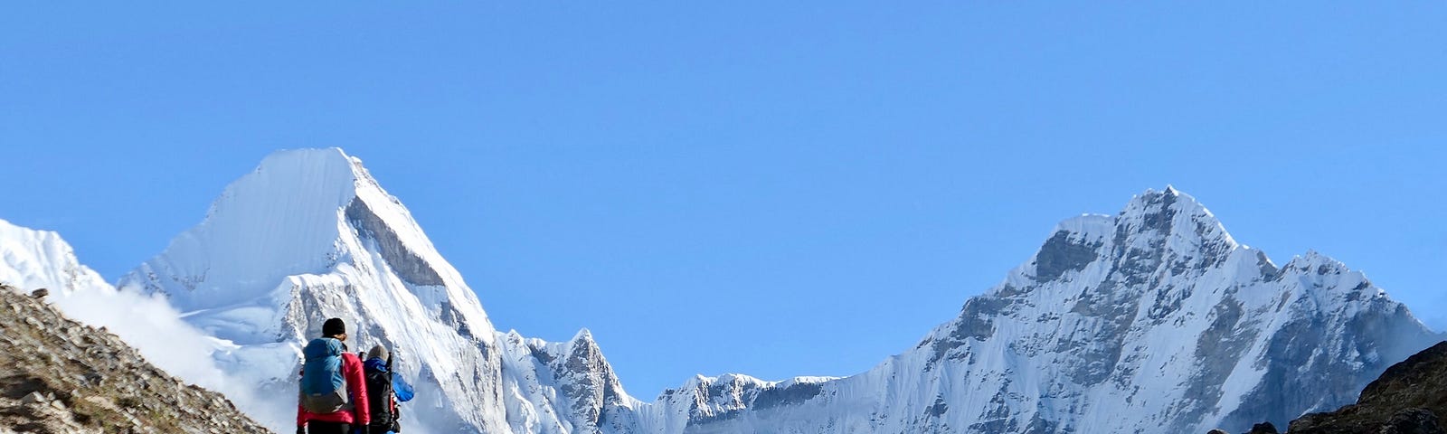 2 hikers walking towards the summit of Mount Everest