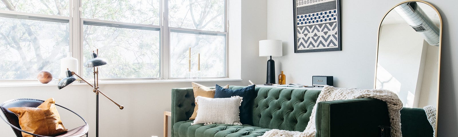 Blueground furnished apartment living room with statement green couch and vintage rug