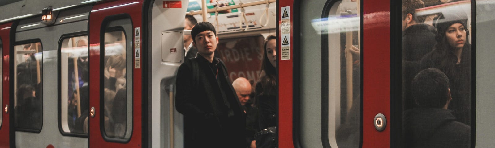 Picture of a tube carriage with the doors open and a man looking out