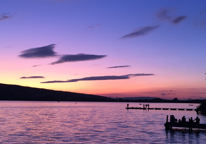 Purple colored sky in the aftermath of a sunset over a large lake