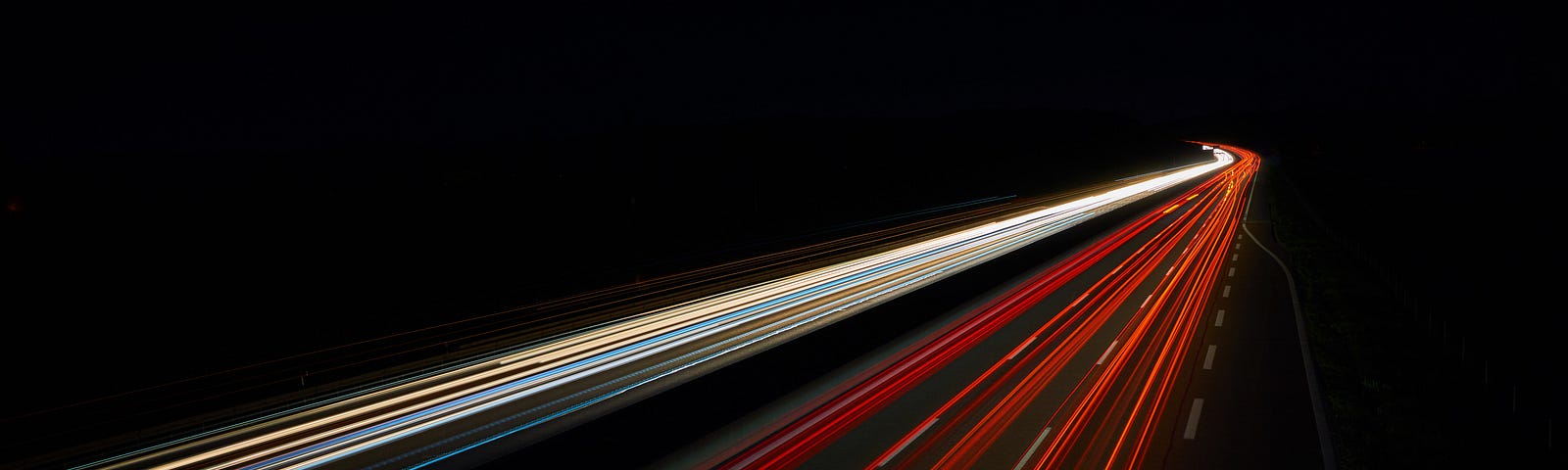 Long-exposure photo of automobile headlights and taillights at speed