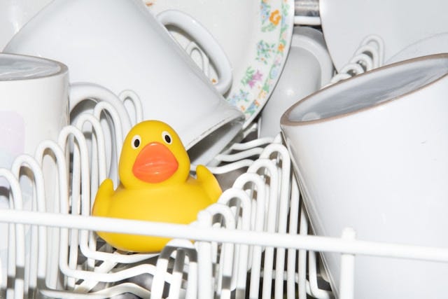 a-yellow-rubber-duck-sitting-in-a-dishwasher