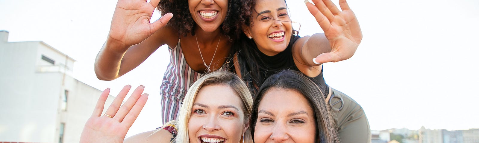 four woman front of camera
