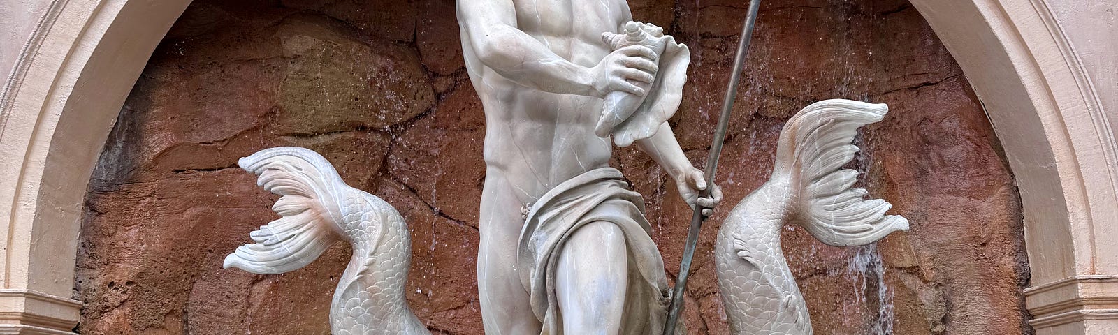 A statue of the roman god Neptune at the entrance to Epcot’s Italian pavilion.