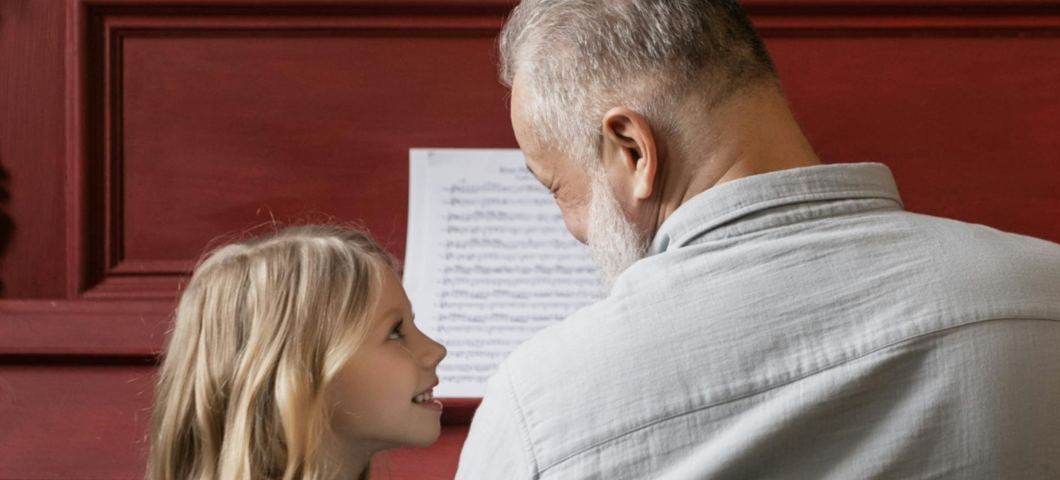 little girl with grandfather at piano