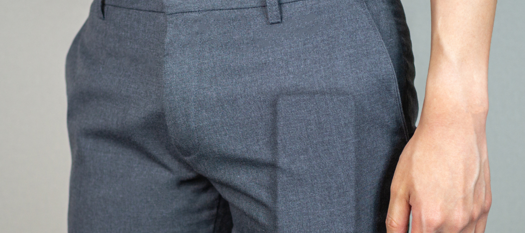 Man with a phone bulging out of his pant pocket.