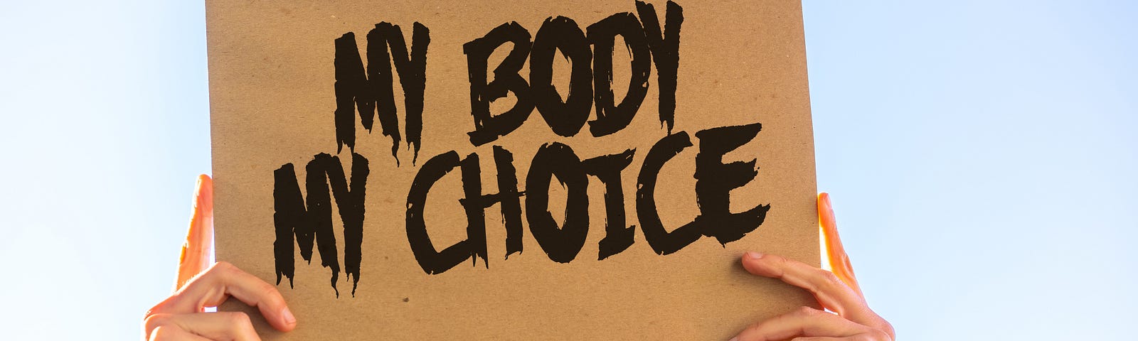 Woman holding a sign that reads “MY BODY MY CHOICE.”