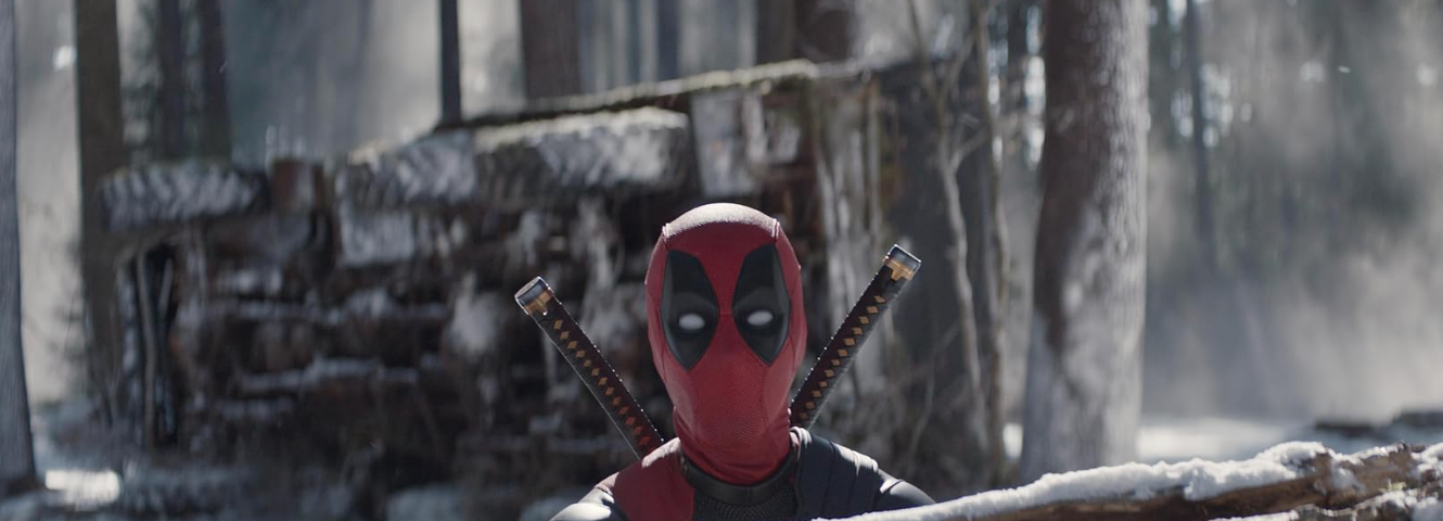 A character, Deadpool, pokes his head out of the rubble. Marvel Film Review Deadpool Wolverine.