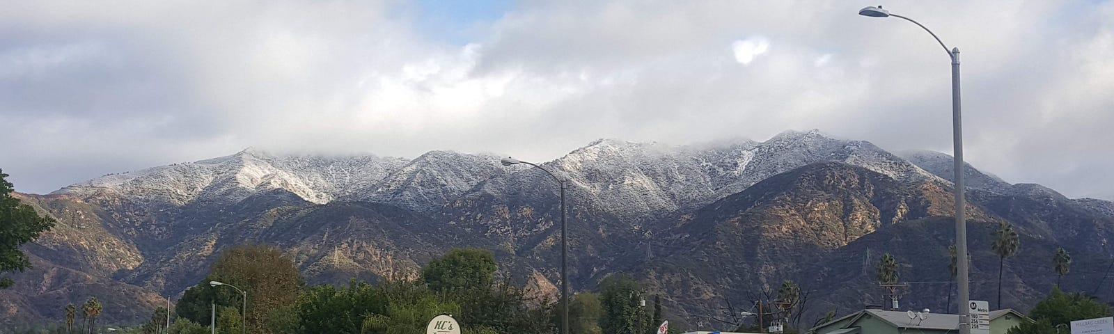 Mountains rising up behind gas station.