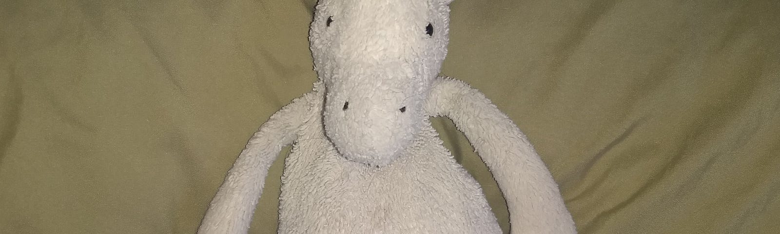 Worn Unicorn stuffed animal