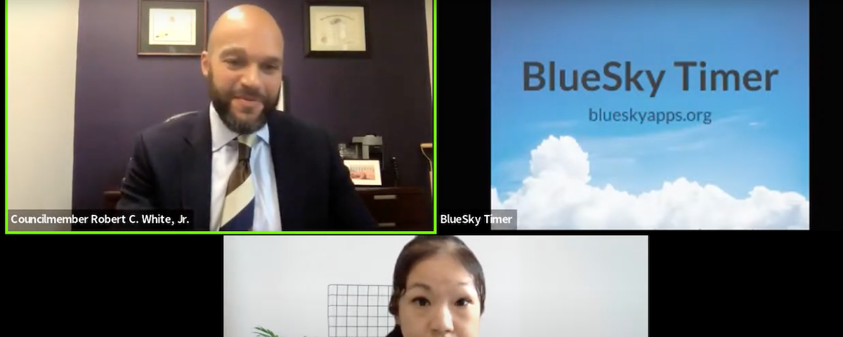 Zoom meeting featuring 3 video windows: Chairperson Robert White in upper left, a testimony countdown timer in upper right, and Senior Associate Cynthia Khoo centered underneath.