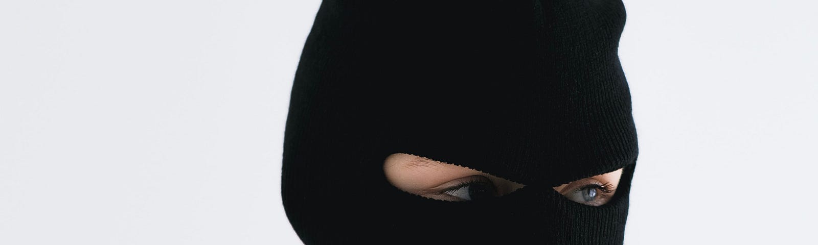 Close-up Shot of a Person Wearing a Robber Mask