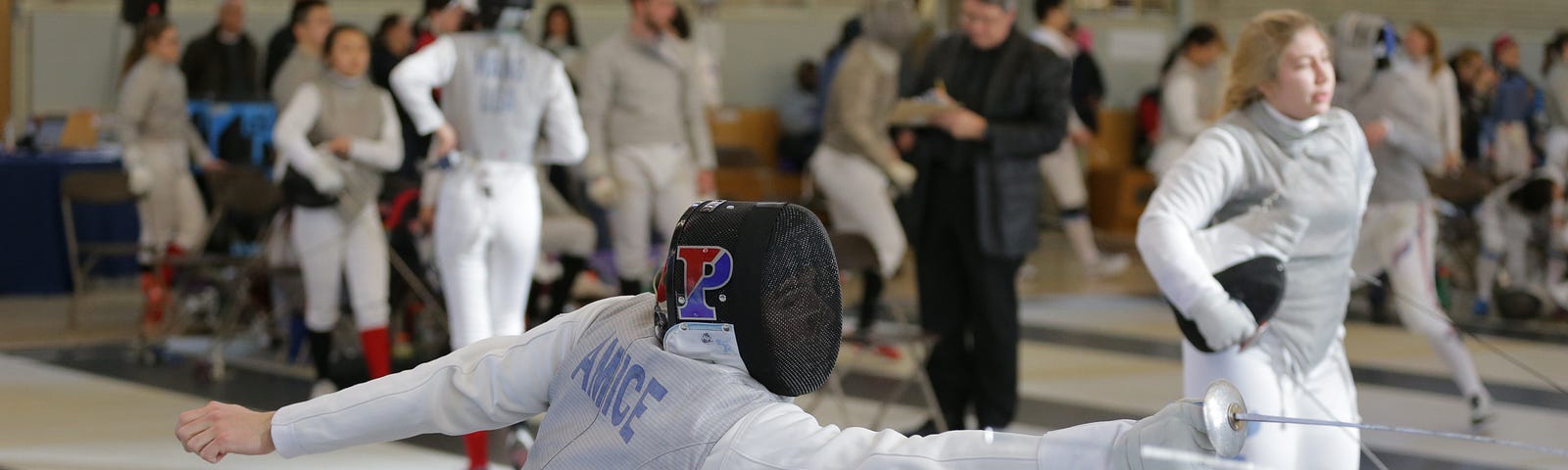 Alexandre Amice lunges in full fencing gear.