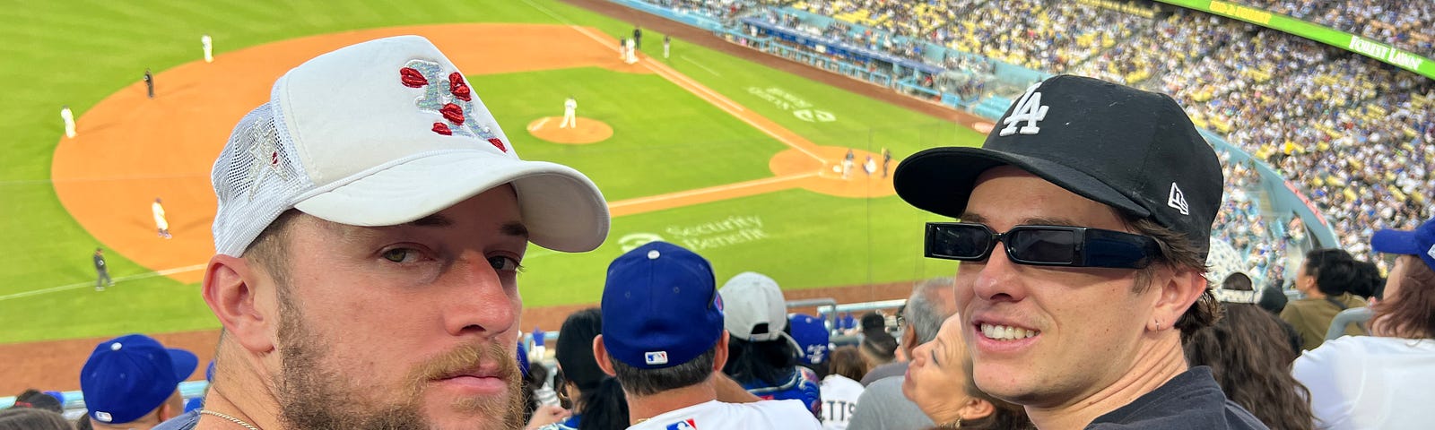 Bryce and Brady look back at me from the top section of Dodger Stadium, as the Dodgers are in the field in the background.